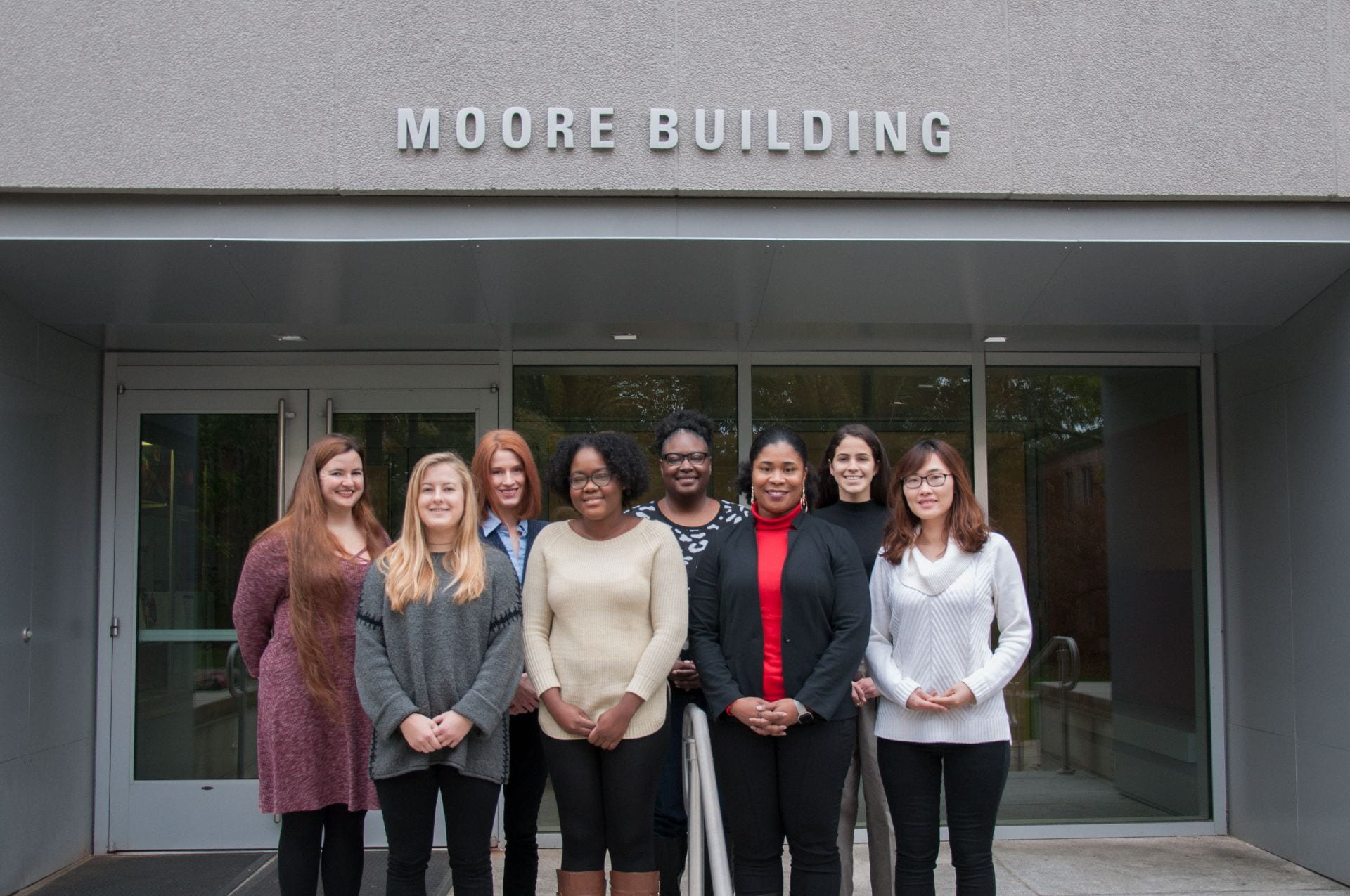 The Context and Development Lab posing outside of the Moore Building